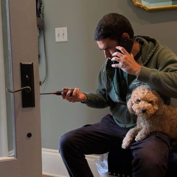 Technician adjusting lock hardware on a residential door
